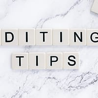 'Editing Tips' spelled out in Scrabble letters on a white marble background