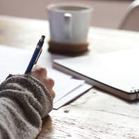 Woman writing something down by hand