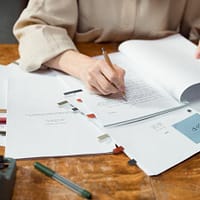 An image showing someone completing a manuscript edit on a physical document