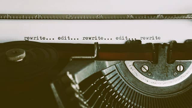 An image showing an older typewriter with the words 'rewrite . . . edit' repeated over and over