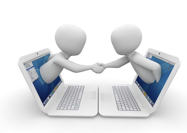 A graphic showing two figures reaching out of laptops to shake hands