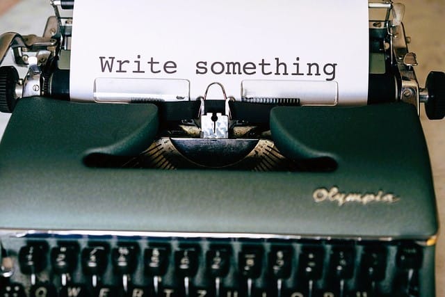 Classic typewriter showing the words 'write something' on a piece of paper